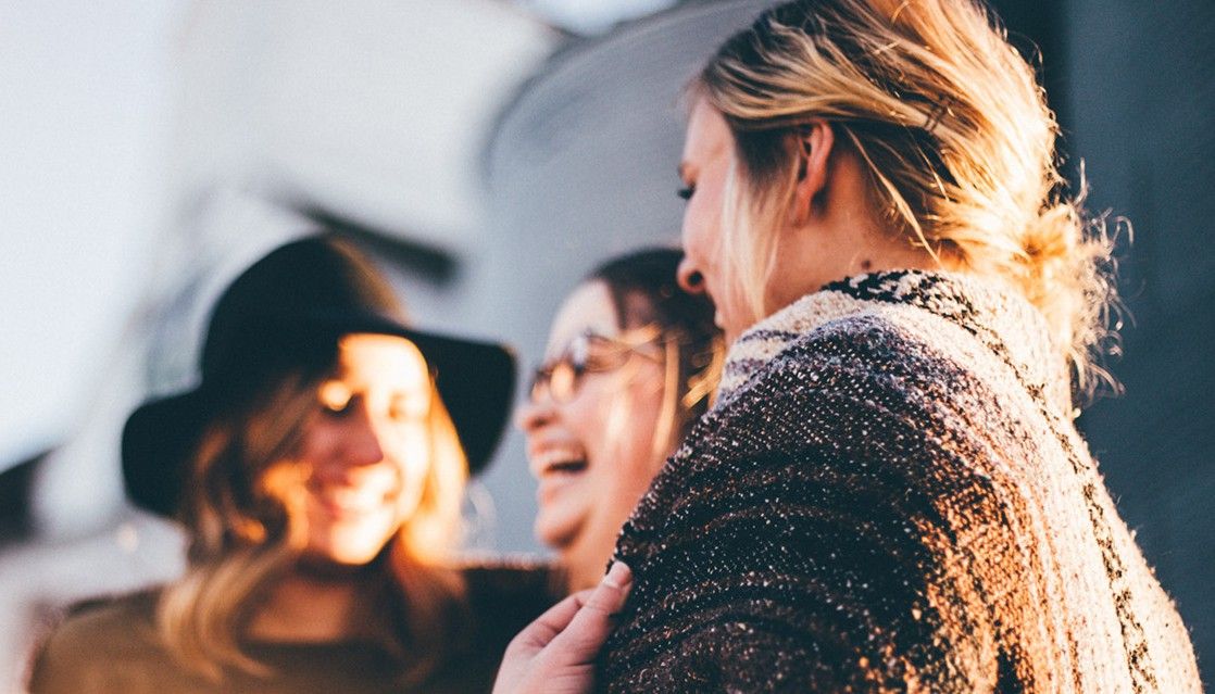 Three women chatting and laughing